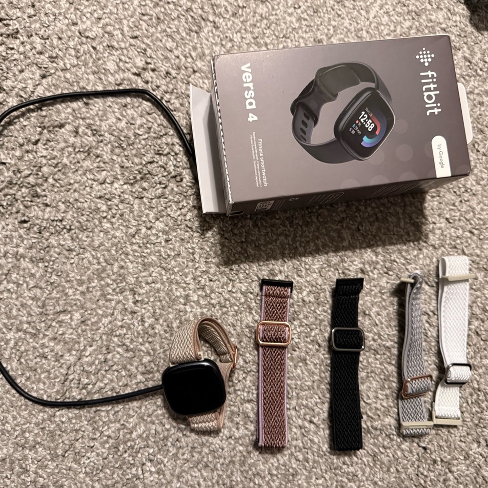Fitbit Versa 4 with Black, Pink, and White Bands